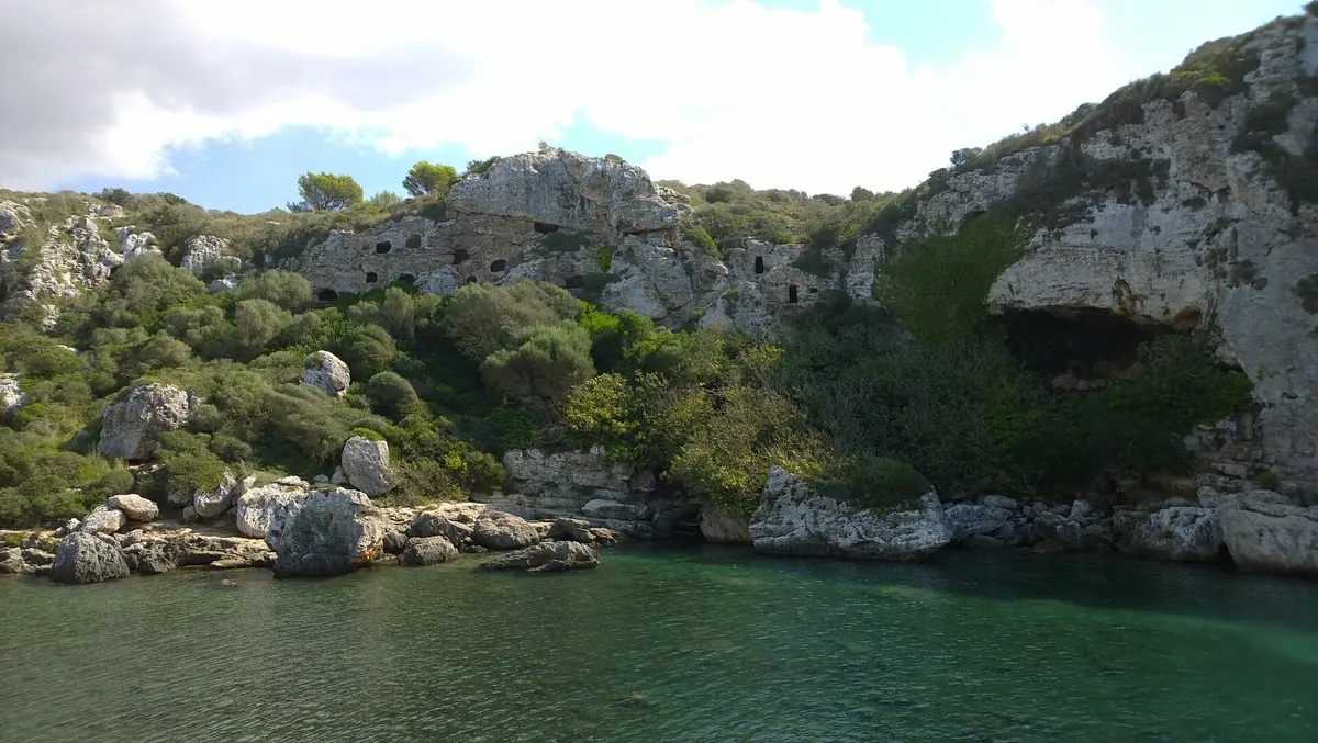 Cala en Turqueta in Menorca seen from above, a cove at the end of both a coast-path walk and a boat half-day loop