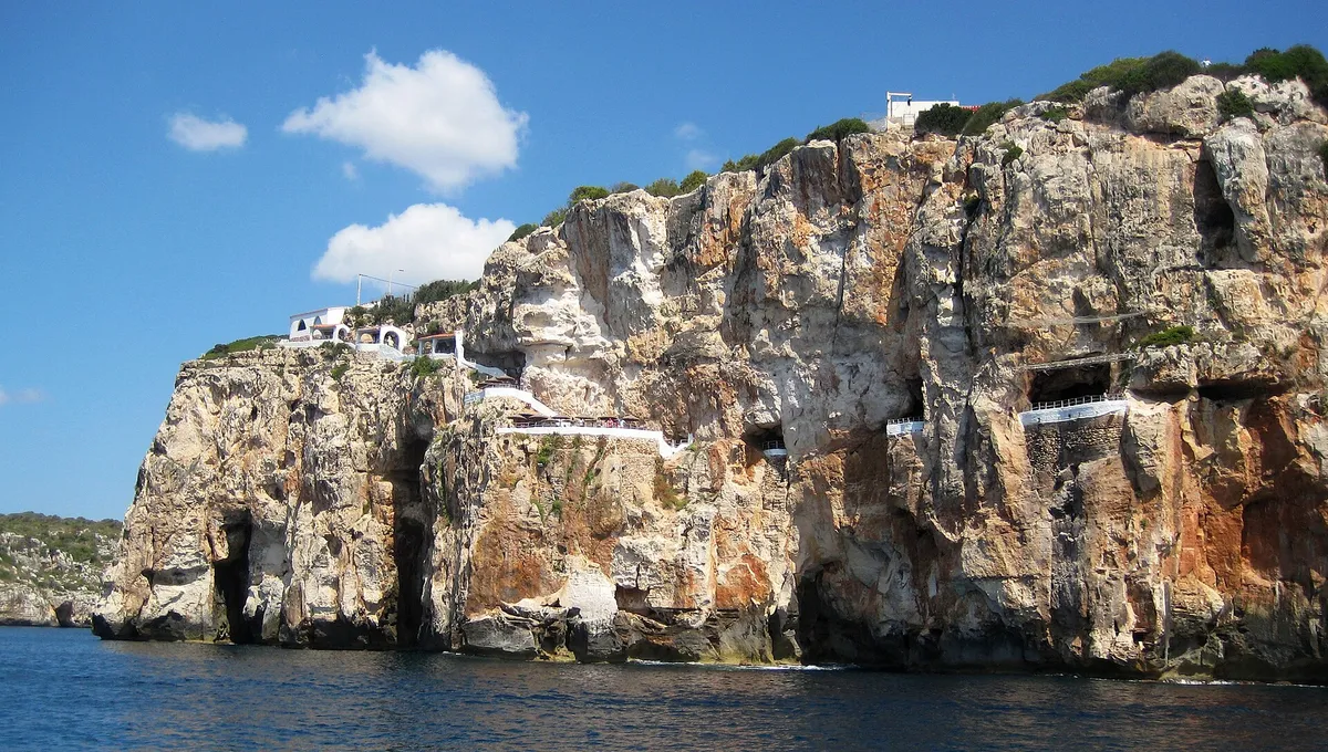 Sea cave mouth under the south-coast cliffs of Menorca seen from the water - the coast a menorca kayak tour or boat trip decision is really about