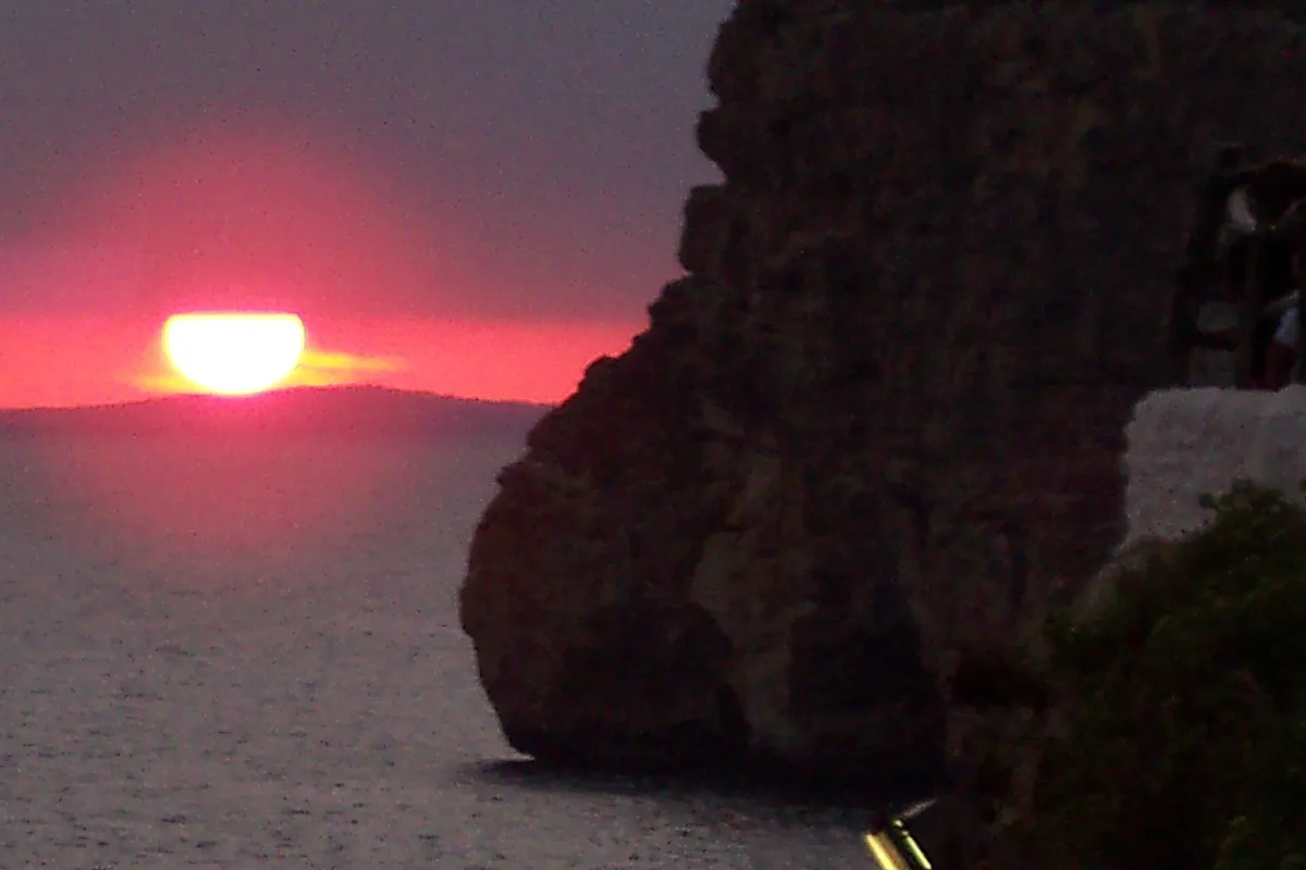 Sunset light at the cliff cave of Cova d'en Xoroi near Cala en Porter in Menorca, the evening the sunset sail sells