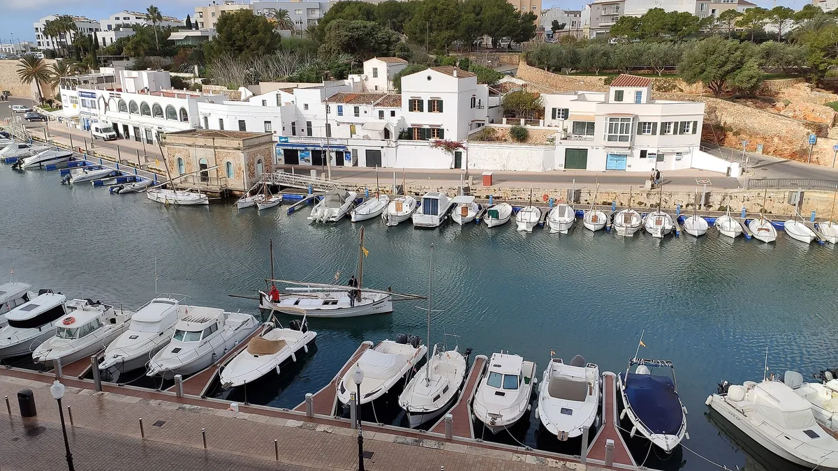 Quayside and moored boats in Ciutadella port, Menorca, where the west-coast day cruise boards for the south-coast cove runs