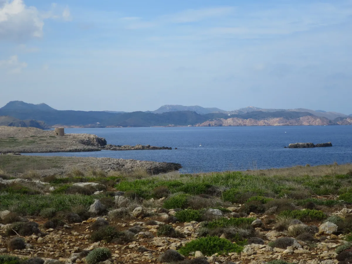 Exposed north-coast headland at Cap de Cavalleria in Menorca where tramontana wind sweeps the water that north-coast boat trips sail